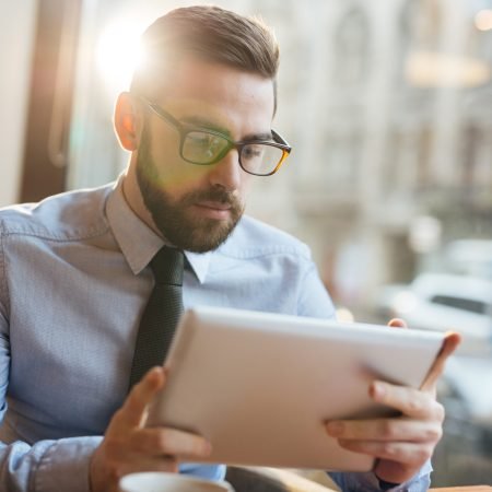 Serious trader looking through financial data online