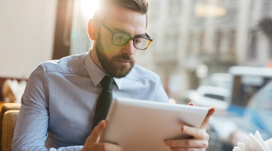 Serious trader looking through financial data online